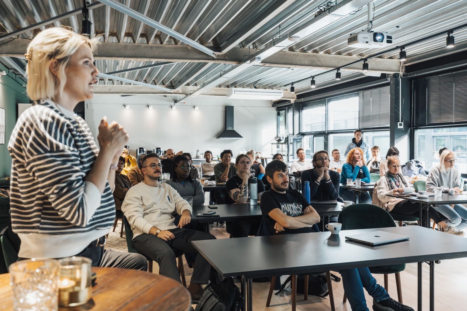 A room of people listening to a talk